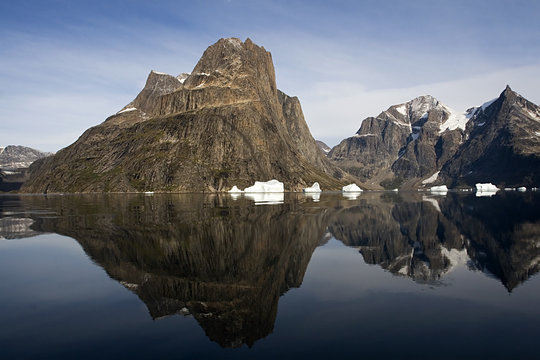 Reflection of mountain in the water in Sermilik Fjord