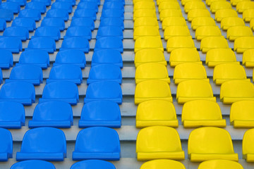 Blue and yellow empty stadium seats