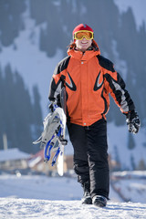Lucky boy  snowboarder in a mountain valley
