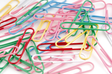 Colored paper clips on white