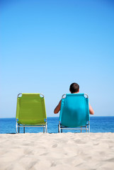Man relaxing on sunbed at a beautiful beach
