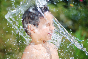 Very cute child playing with water outdoor