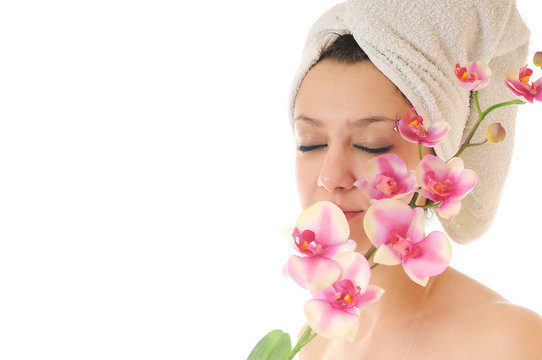 beautiful young  woman face with flower and towel