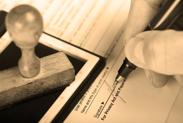 Signature with stamp on inkpad. Sepia toned