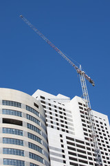 Fototapeta na wymiar Construction site with big cranes and blue sky