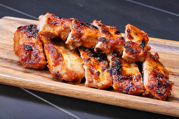 Grilled pork ribs on wooden plate