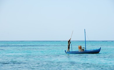 Typical Maldivian boat on blue ocean
