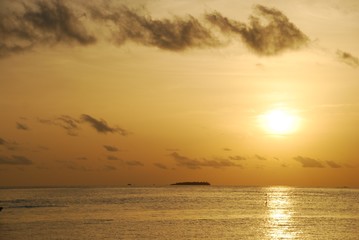Fototapeta na wymiar Beautiful orange sunset on a tropical beach