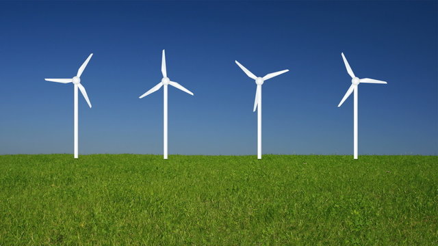 windkraftanlage auf einer wiese mit blauem himmel