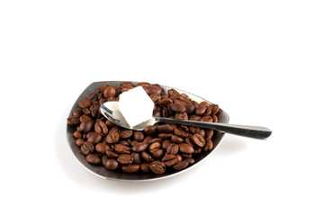 Cup of coffee with grains and sugar