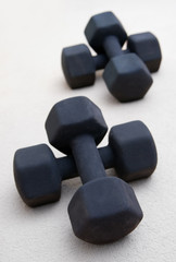 Solid black weights stacked in a gym