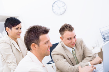 Businesspeople using laptop