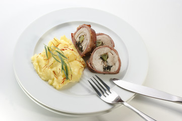 mashed potato and chicken roll on a white plate