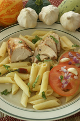 Pasta with chicken meat and organic tomato