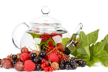 Teapot with fruit tea and green leaves