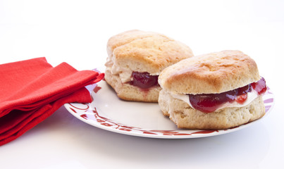 Home-baked scones with strawberry jam and clotted cream, often s