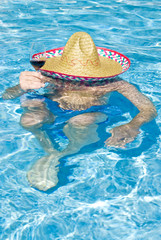 Man Wearing Sombrero in Swimming Pool