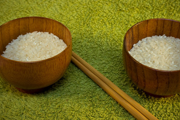 bowls with rice and sticks on green