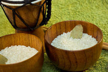 wooden bowls with rice and tamtam on green