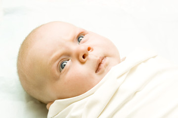 newborn baby with blue eyes looking upwards