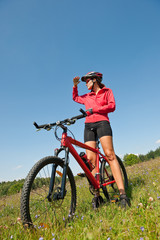 Fototapeta na wymiar Young sportive woman on mountain bike