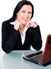 smiling brunette businesswoman in office with laptop