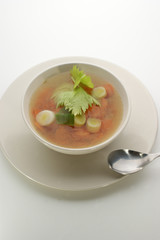 delicious vegetable soup in a white bowl with a spoon
