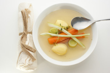 delicious vegetable soup in a white bowl with a spoon