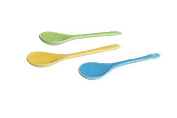 colourful teaspoons on white background