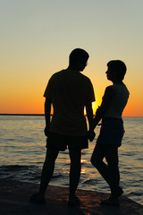 romantic pair looking at each other at sunset