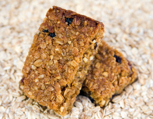 Two flapjacks stacked on an oat background