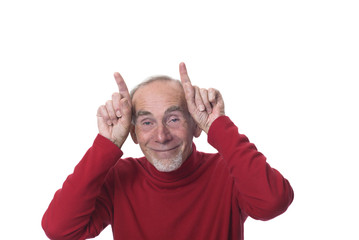 Old man making devil horns with fingers on head