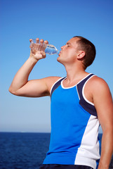 Man drinking water after running