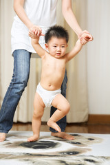 Mother guide her son to walk