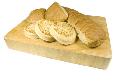 rolls, baps, muffins on bread board isolated on white background