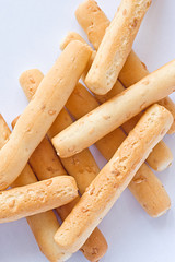Sesame seed breadsticks on white