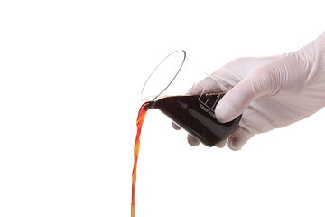 White gloved hand  pouring red liquid from flask