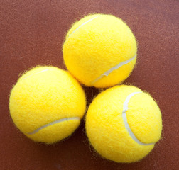 three tennis balls together in yellow
