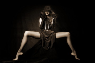 girl with long legs against black background