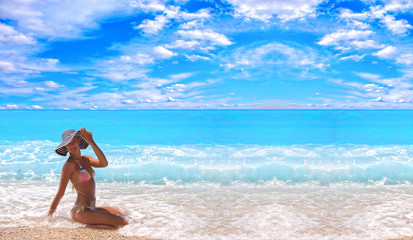 tanned blond woman in bikini in the sea