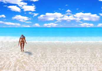 Fototapeta na wymiar tanned blond woman in bikini in the sea