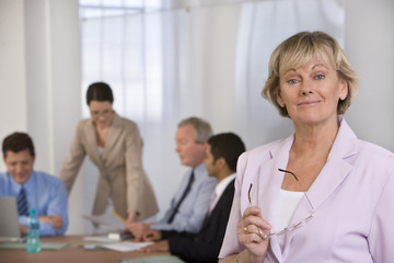 Portrait of businesswoman and her colleauges.