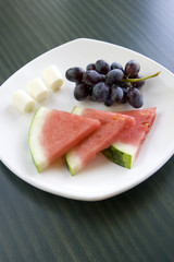A healthy treat of cheese, watermelon, and grapes.