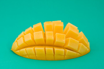 Ripe mango on a green background