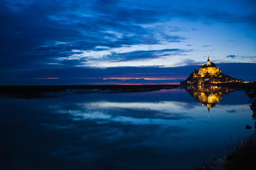 Mont St. Michel reflected in the sea at night