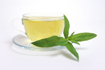 Tea cup with mint leaves on a white background