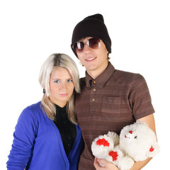 Fototapeta na wymiar Smiling teenage couple with toy bear