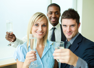 Happy businessteam with champagne in office