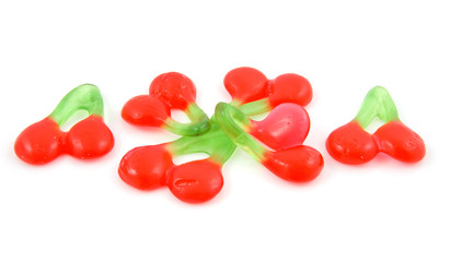 candy in the shape of cherries over white background