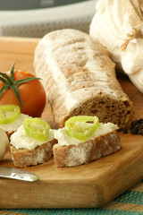 baguette as a snack with cottage cheese and green paprika